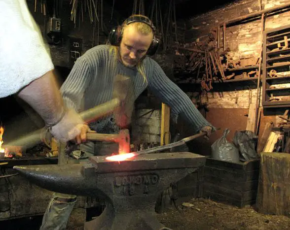 blacksmith working on sledge hammer